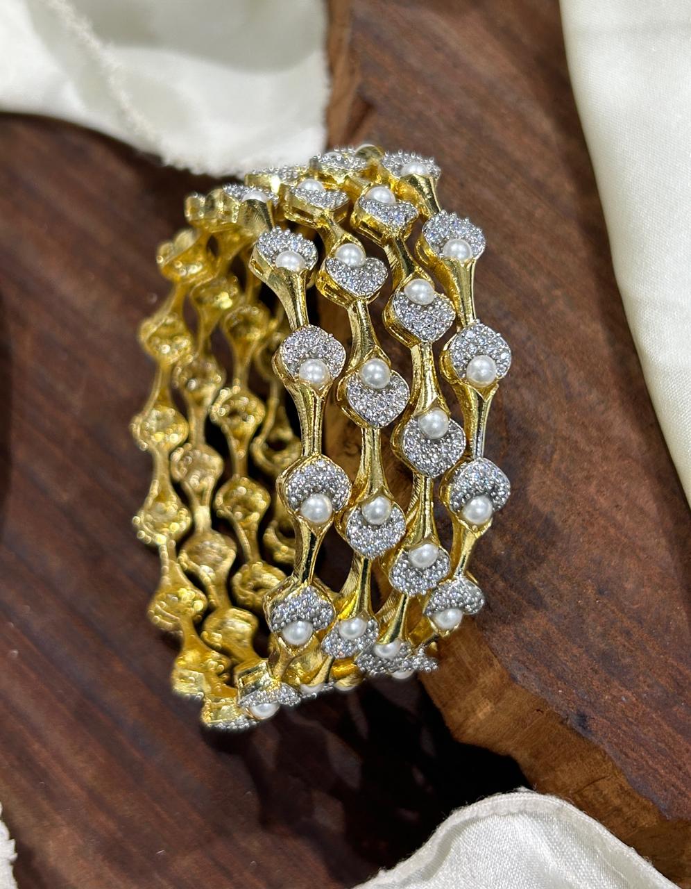 Pearl Petal Bangles, pearl bangles, CZ pearl bangles, CZ bangles, pearl bangle set, South Indian bangles, South Indian jewellery, floral bangles, petal bangles, floral design bangles, dual tone bangles, gold plated bangles, rhodium plated bangles, gold and rhodium bangles, 4 piece bangle set, sleek bangles, traditional bangles, bridal bangles, wedding bangles, party wear bangles, festive bangles, designer bangles, Indian bangles, Pakistani jewellery, South Indian floral bangles