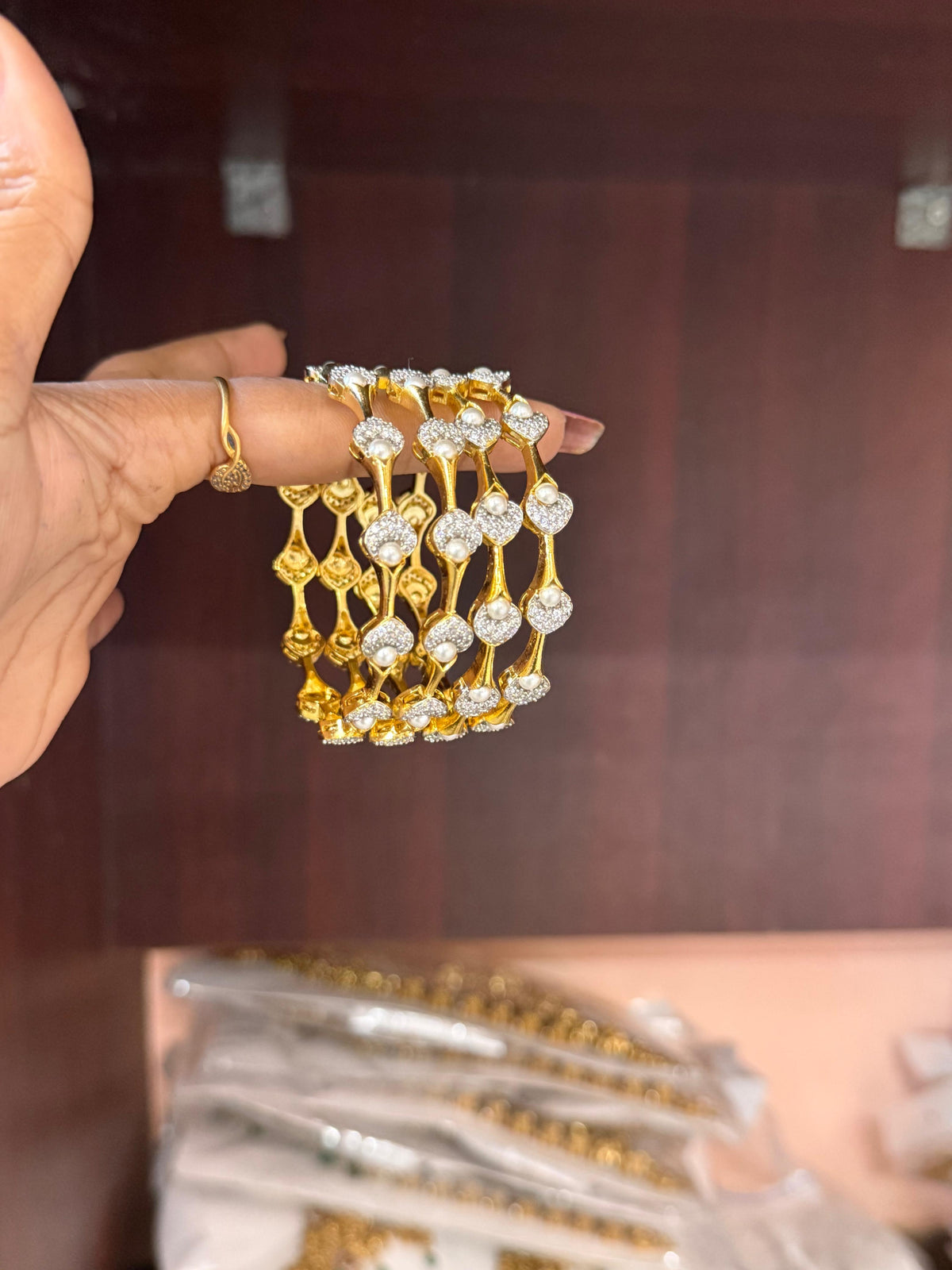 Pearl Petal Bangles, pearl bangles, CZ pearl bangles, CZ bangles, pearl bangle set, South Indian bangles, South Indian jewellery, floral bangles, petal bangles, floral design bangles, dual tone bangles, gold plated bangles, rhodium plated bangles, gold and rhodium bangles, 4 piece bangle set, sleek bangles, traditional bangles, bridal bangles, wedding bangles, party wear bangles, festive bangles, designer bangles, Indian bangles, Pakistani jewellery, South Indian floral bangles
