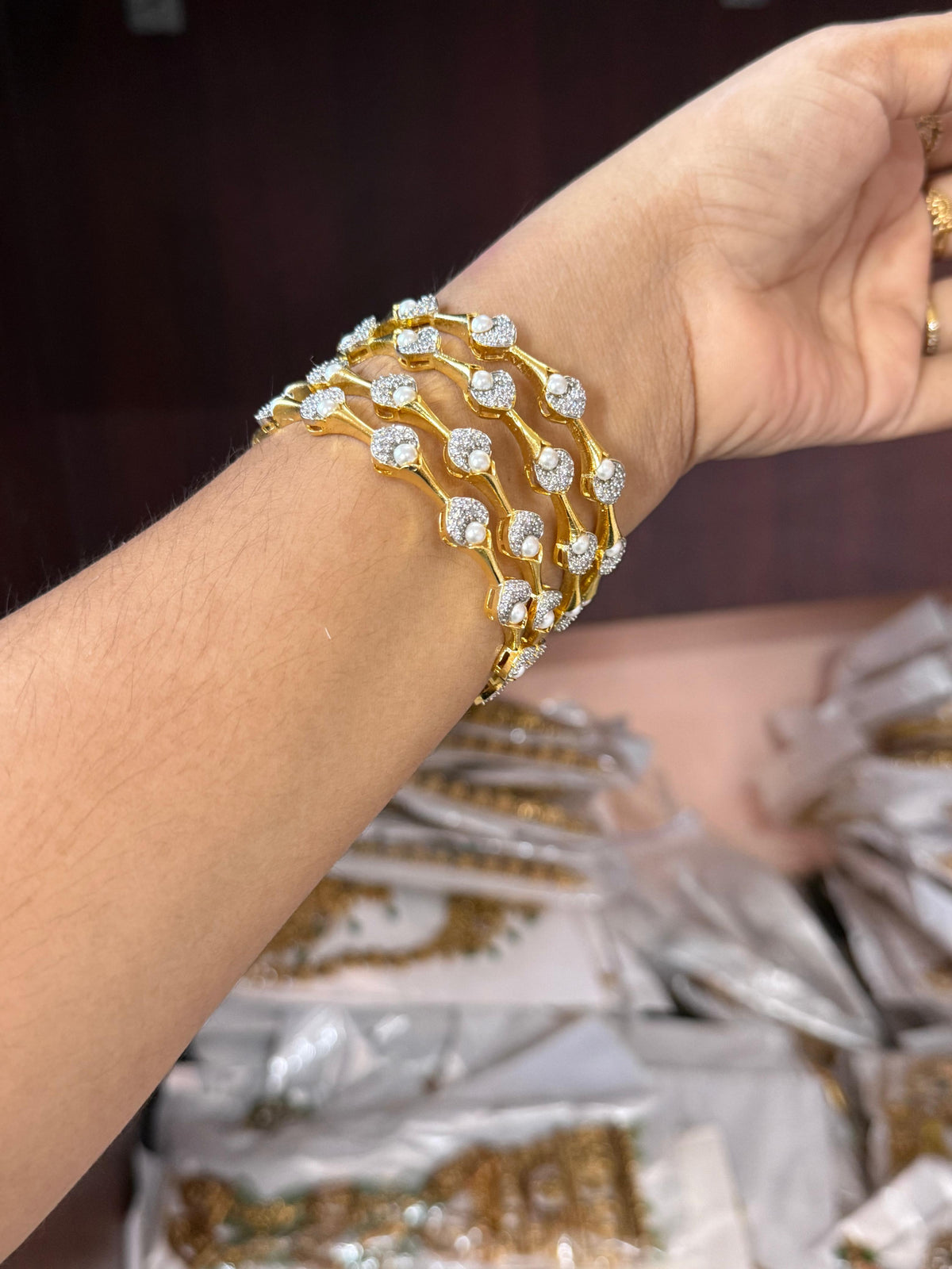 Pearl Petal Bangles, pearl bangles, CZ pearl bangles, CZ bangles, pearl bangle set, South Indian bangles, South Indian jewellery, floral bangles, petal bangles, floral design bangles, dual tone bangles, gold plated bangles, rhodium plated bangles, gold and rhodium bangles, 4 piece bangle set, sleek bangles, traditional bangles, bridal bangles, wedding bangles, party wear bangles, festive bangles, designer bangles, Indian bangles, Pakistani jewellery, South Indian floral bangles