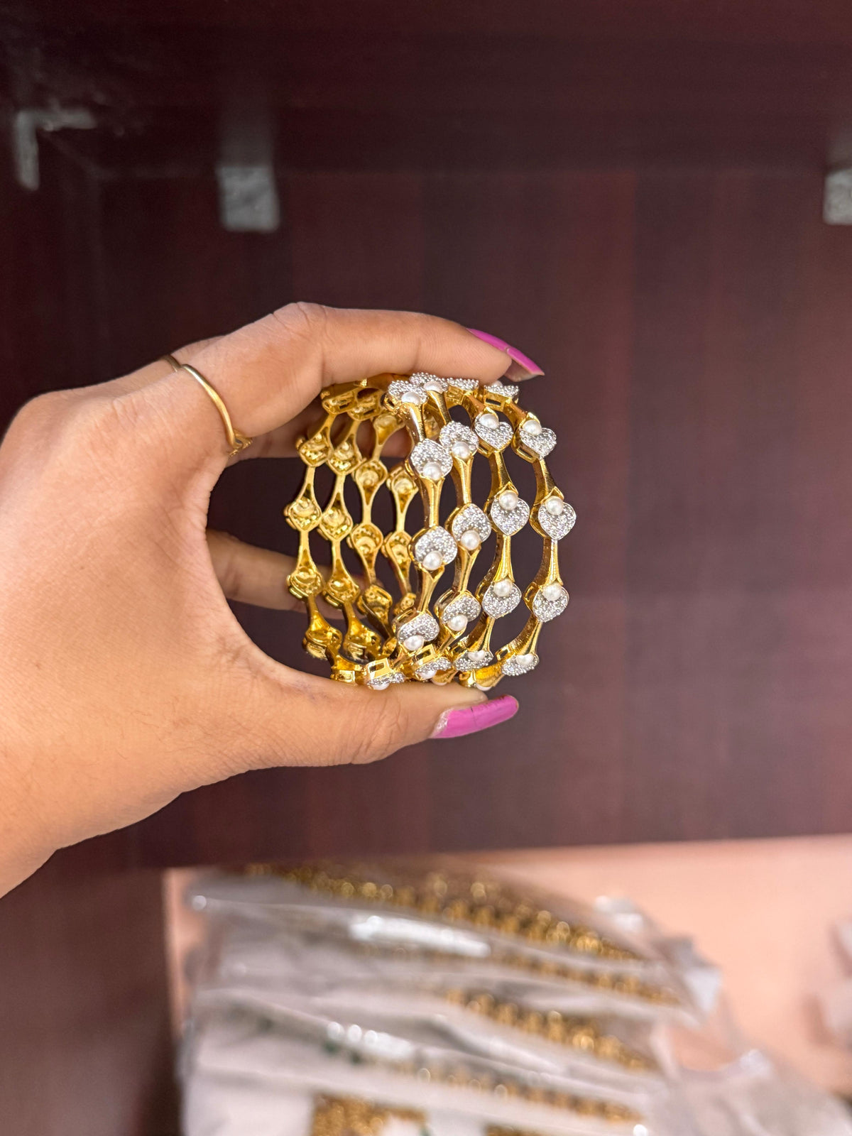 Pearl Petal Bangles, pearl bangles, CZ pearl bangles, CZ bangles, pearl bangle set, South Indian bangles, South Indian jewellery, floral bangles, petal bangles, floral design bangles, dual tone bangles, gold plated bangles, rhodium plated bangles, gold and rhodium bangles, 4 piece bangle set, sleek bangles, traditional bangles, bridal bangles, wedding bangles, party wear bangles, festive bangles, designer bangles, Indian bangles, Pakistani jewellery, South Indian floral bangles