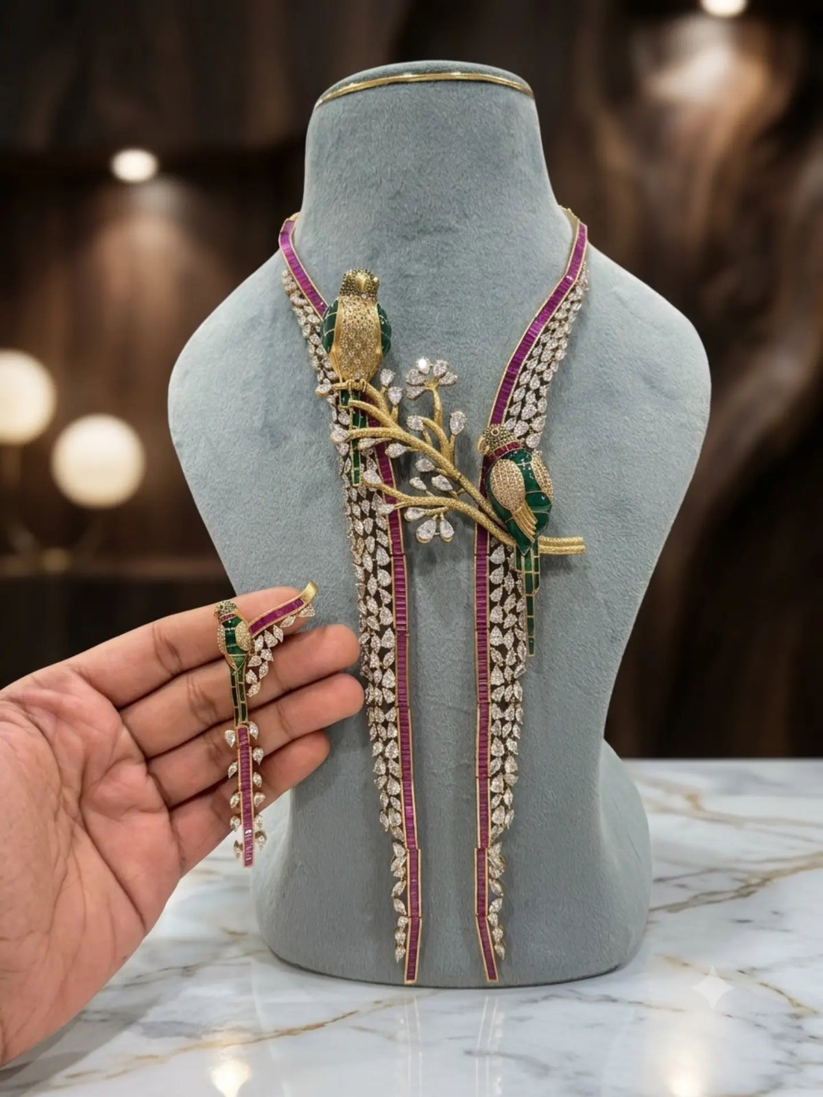 royal bird jewellery set, bird necklace set, floral statement necklace, green enamel jewellery, bridal statement jewellery, Pakistani bridal jewellery, Indian bridal jewellery, luxury necklace set, designer necklace set, statement jewellery set, wedding jewellery set, bridal necklace earrings set, green stone necklace, marquise stone necklace, magenta stone jewellery, floral bridal necklace, royal jewellery set, Pakistani wedding jewellery, traditional statement jewellery, Gulmohar jewellery