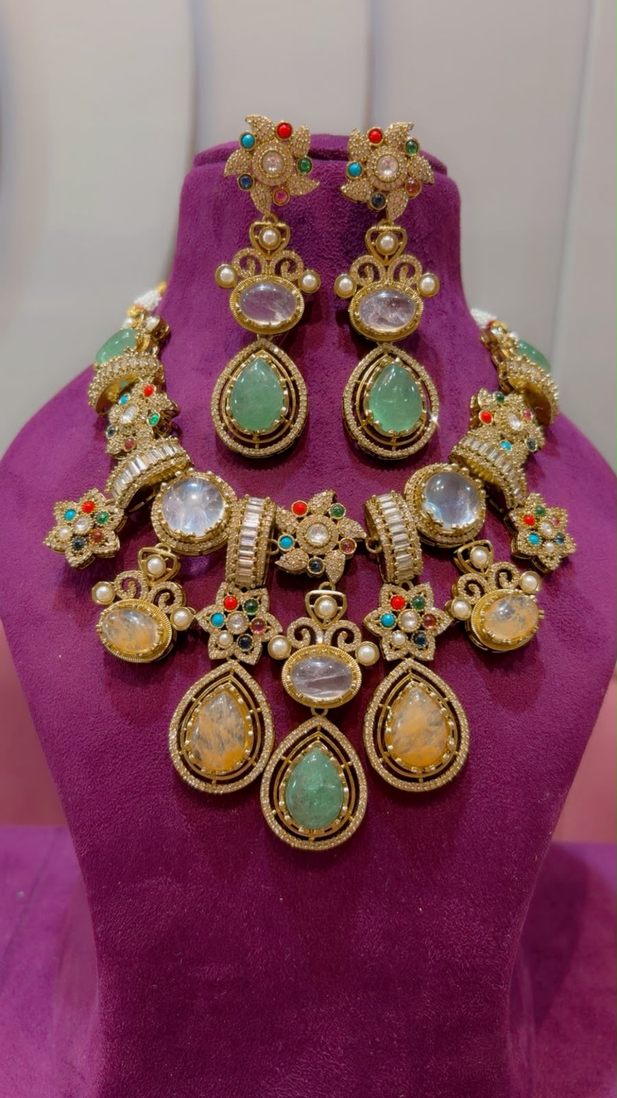 Front view of handcrafted gold-plated fusion necklace and statement earrings featuring colorful floral motifs and CZ baguette links