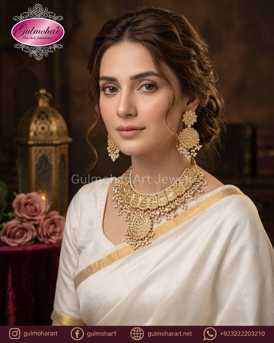  Model wearing Gulmohar gold Kundan Polki necklace set with pearl dangles and plain white saree.
