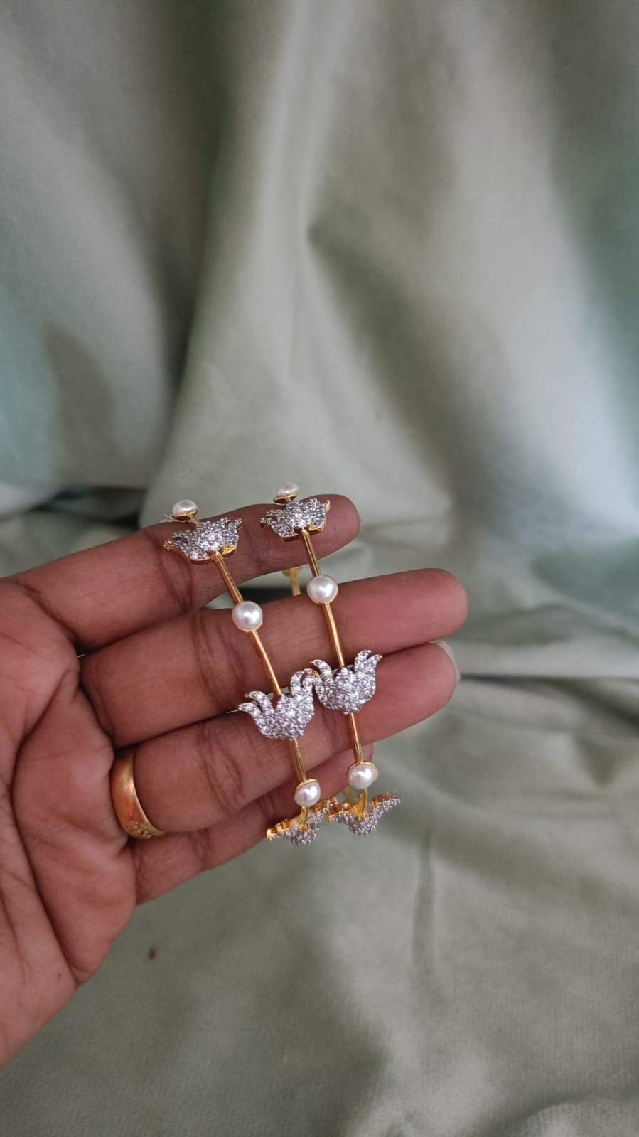 Lotus bangles, Lotus bangle set, CZ pearl bangles, CZ bangles, pearl bangles, gold plated bangles, rhodium plated bangles, dual tone bangles, South Indian bangles, South Indian jewellery, floral bangles, floral design bangles, 2 piece bangle set, sleek bangles, traditional bangles, designer bangles, bridal bangles, wedding bangles, party wear bangles, festive bangles, gold and rhodium bangles, CZ pearl jewellery, Indian bangles, Pakistani jewellery